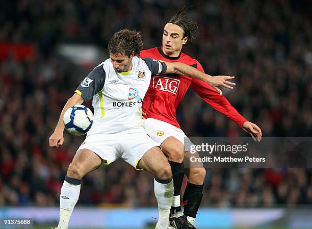 Dimitar Berbatov of Manchester United clashes with Lorik Cana of Sunderland during the Barclays Premier League match between Manchester United and...