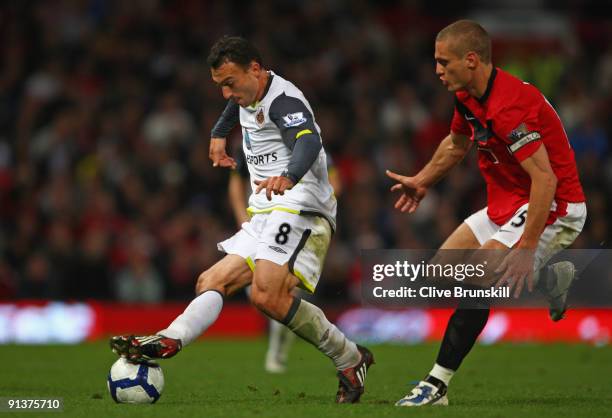 Steed Malbranque of Sunderland goes past Nemanja Vidic of Manchester United during the Barclays Premier League match between Manchester United and...