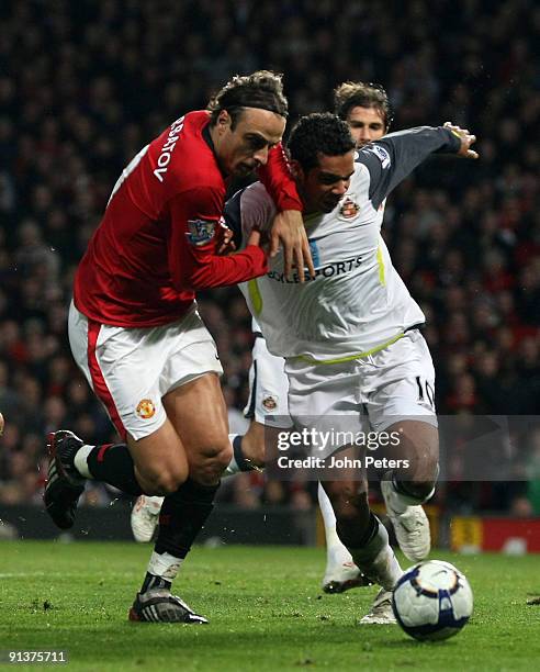 Dimitar Berbatov of Manchester United clashes with Kieran Richardson of Sunderland during the FA Barclays Premier League match between Manchester...