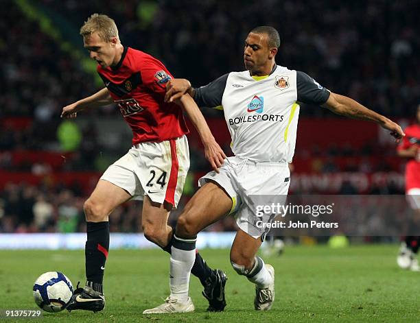 Darren Fletcher of Manchester United clashes with Anton Ferdinand of Sunderland during the FA Barclays Premier League match between Manchester United...