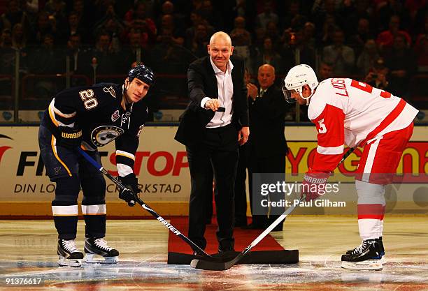 Nicklas Lidstrom of Detroit Red Wings and Alexander Steen of St. Louis Blues have a ceremonial face-off with recently retired player Mats Sundin...