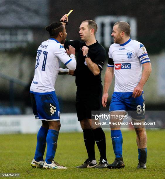 Referee Jeremy Simpson shows Bury's Neil Danns the yellow card during the Sky Bet League One match between Bury and Blackpool at Gigg Lane on...