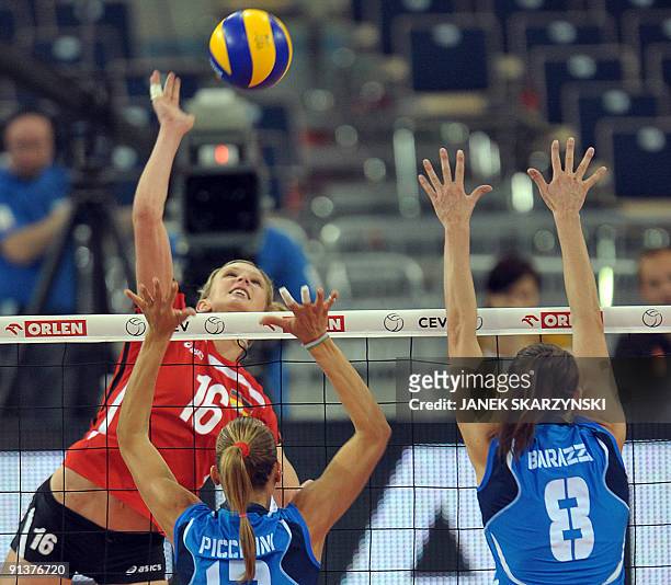 Margareta Anna Kozuch of Germany spikes the ball against Francesca Piccinini and Jenny Barazza of Italy during their women's European volley-ball...