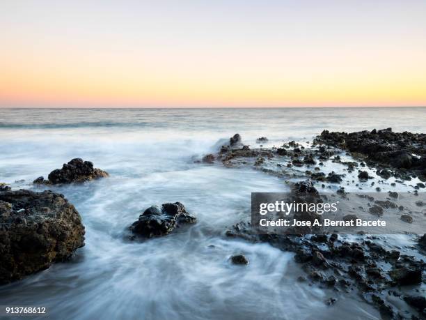 sunset on the beach and rocky coast of the cabo de gata with formations of volcanic rock.  cabo de gata - nijar natural park, cala monsul, beach, biosphere reserve, almeria,  andalusia, spain - biosphere planet earth stockfoto's en -beelden