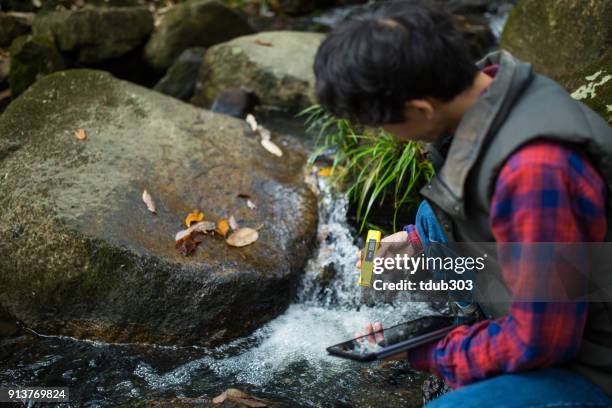 a scientist or researcher testing water quality with a ph meter - ph value stock pictures, royalty-free photos & images