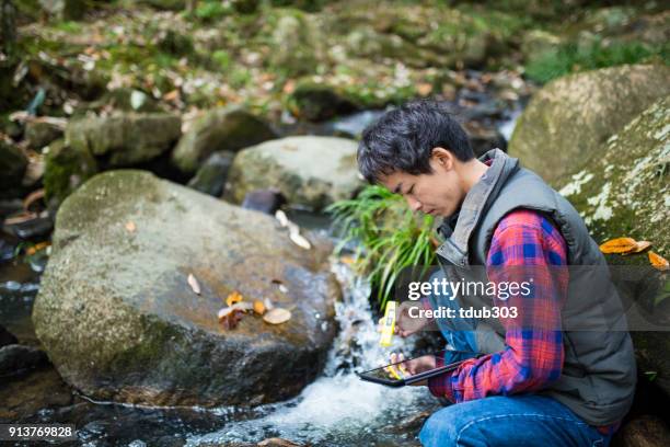 a scientist or researcher testing water quality with a ph meter - ph balance stock pictures, royalty-free photos & images