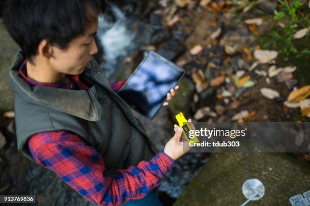 a scientist or researcher testing water quality with a ph meter - ph value stock pictures, royalty-free photos & images