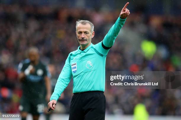 Referee Martin Atkinson gestures during the Premier League match between Burnley and Manchester City at Turf Moor on February 3, 2018 in Burnley,...