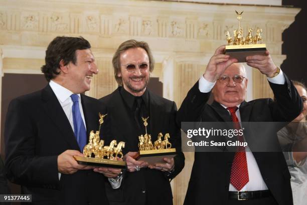 European Commission President Jose Manuel Barroso, German singer Marius Mueller Westernhagen and former Soviet President Mikhail Gorbachev hold their...