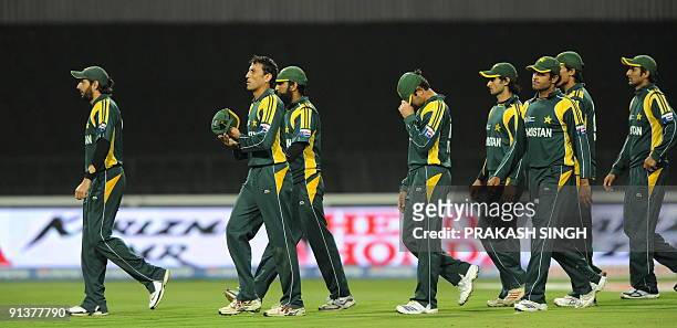 Pakistan's captain Younus Khan walks along with teammates back to pavillion after losing against New Zealand during ICC Champions Trophy 2nd...