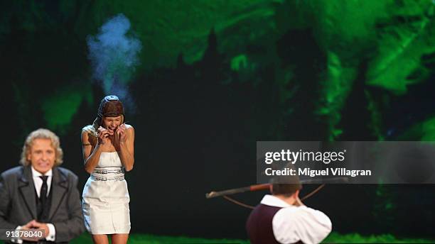 Swiss gunmen pretends to shoot towards Michelle Hunziker whilst host Thomas Gottschalk reacts to the noise during the Wetten dass...? show at the...