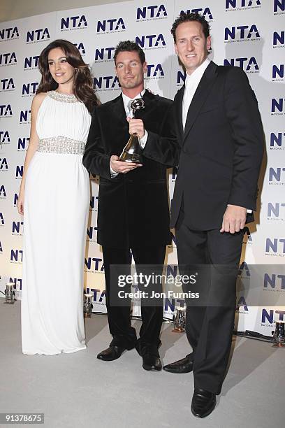 Actor Dean Gaffney poses with the award for Most Popular Reality Programme for 'I'm a celebrity, get me out of here!', presented by actress Kelly...