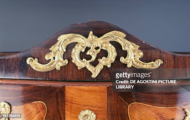 Golden bronze decoration of a Louis XV style commode, oak and fir wood, with rosewood veneer on drawers, light wood details; red Flanders marble...