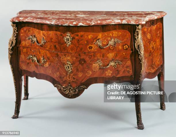 Louis XV style commode, in veneered wood and inlaid with flowers, leaves, birds and butterflies, red marble top, arched legs and chiseled and golden...