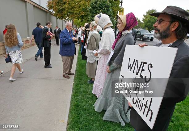 Street preacher Jerry Holt and several of his followers stand in protest to try inform Mormons of the many wives of Mormon founder Joseph Smith at...