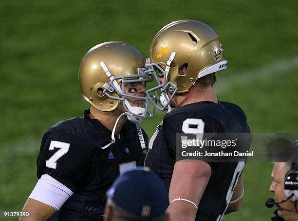 Jimmy Clausen and Kyle Rudolph of the Notre Dame Fighting Irish celebrate a 4th quarter touchdown on the sidelines against the Washington Huskies on...