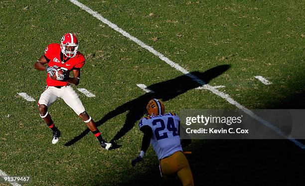 Tavarres King of the Georgia Bulldogs pulls in a reception against Harry Coleman of the Louisiana State University Tigers at Sanford Stadium on...