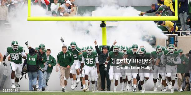 Michigan State head coach Mark Dantonio leads his team onto the field prior to the start of the game against the Michigan Wolverines at Spartan...