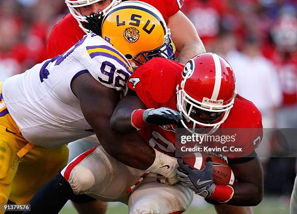 Drake Nevis of the Louisiana State University Tigers tackles Washaun Ealey of the Georgia Bulldogs at Sanford Stadium on October 3, 2009 in Athens,...