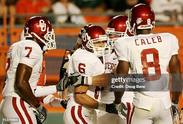 Matt Clapp, Brandon Caleb and DeMarco Murray of Oklahoma Sooners celebrate with wide receiver Cameron Kenney after Kenney scored a touchdown in the...