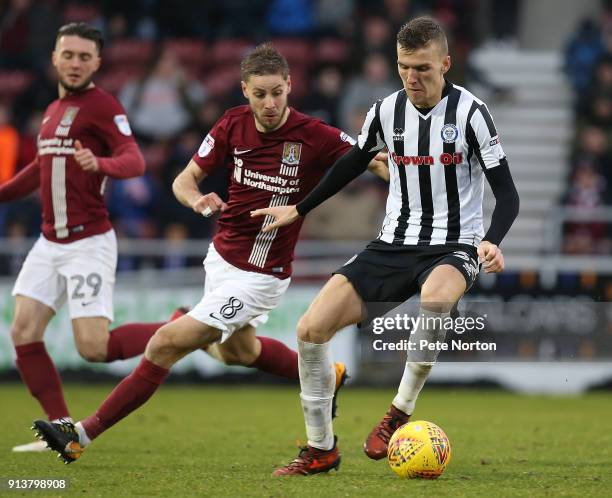 Mark Kitching of Rochdale controls the ball under pressure from Sam Foley of Northampton Town during the Sky Bet League One match between Northampton...