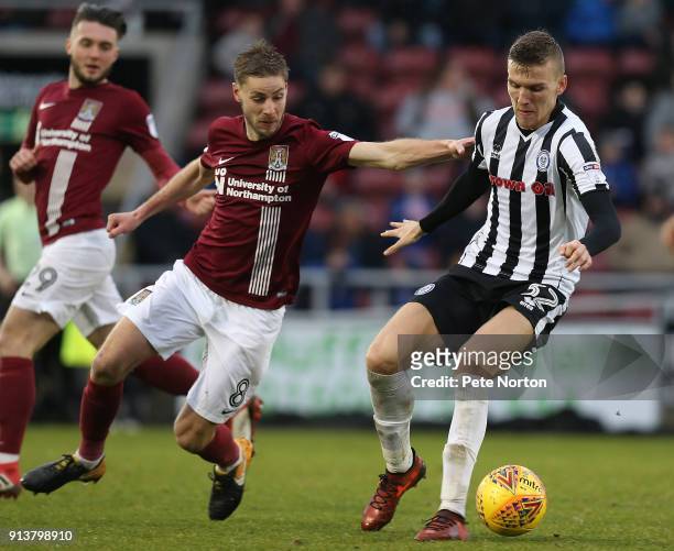 Mark Kitching of Rochdale controls the ball under pressure from Sam Foley of Northampton Town during the Sky Bet League One match between Northampton...
