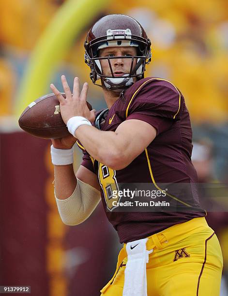 Adam Weber of the Minnesota Golden Gophers passes the ball during warmups in a NCAA football game against the Wisconsin Badgers on October 3, 2009 at...
