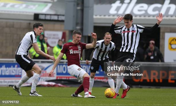 Chris Long of Northampton Town challenges for the ball with Jim McNulty and Ryan Delaney of Rochdale during the Sky Bet League One match between...