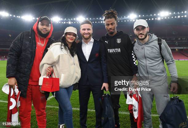 Shkodran Mustafi and Sead Kolasinac of Arsenal meet pop star Rihanna after the Premier League match between Arsenal and Everton at Emirates Stadium...