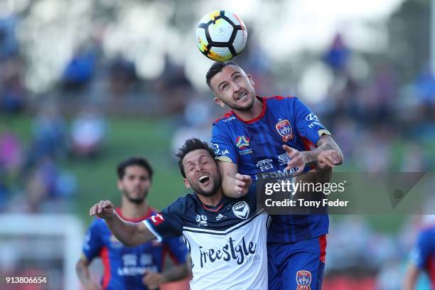 Roy O'Donovan of the Jets contests a header with Matias Sanchez of the Victory during the round 19 A-League match between the Newcastle Jets and the...