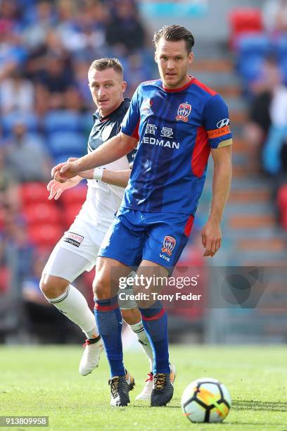 Nigel Boogaard of the Jets contests the ball with Besart Berisha of the Victory during the round 19 A-League match between the Newcastle Jets and the...