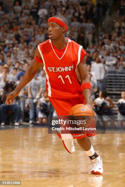 Cedric Jackson of the St. John's Red Storm dribbles the ball during a college basketball game against the Georgetown Hoyas at the MCI Center on...