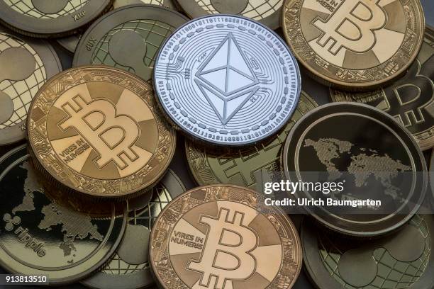 Symbol photo on the topics cryptocurrency, digital currency, Speculation, currency speculation, etc. The picture shows Ethereum, Bitcoin and Ripple...