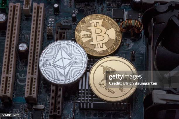 Symbol photo on the topics cryptocurrency, digital currency, Speculation, currency speculation, etc. The picture shows Ethereum, Bitcoin and Ripple...