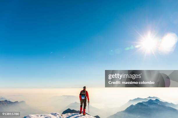 man alpinist on top of the mountain - caucasian mountain climber man stock-fotos und bilder