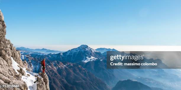 mountaineer looking mountain valley from the top - on top of stock pictures, royalty-free photos & images