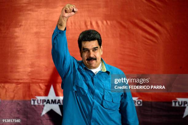 Venezuelan President Nicolas Maduro raises his fist during a rally in Caracas on February 3, 2018. Venezuelan President Nicolas Maduro urged the...