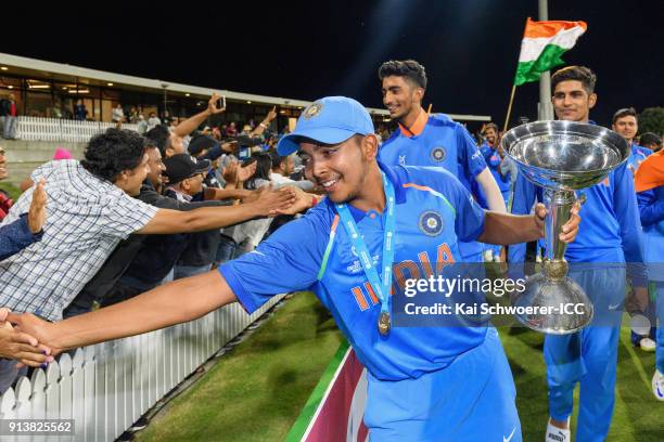 Captain Prithvi Shaw of India greets fans while he holds the trophy after the win in the ICC U19 Cricket World Cup Final match between Australia and...