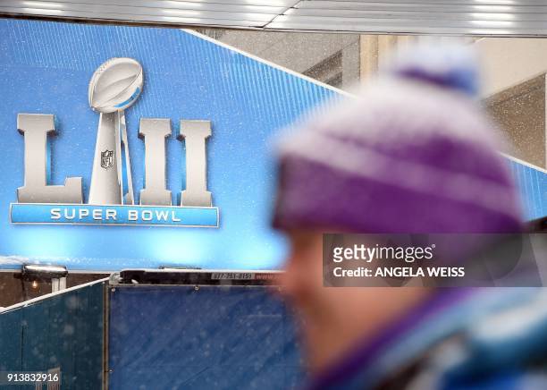 Volunteer stands in the snow during the Super Bowl LIVE, a 10-day fan festival leading up to Super Bowl LII, taking place on Minneapolis Nicollet...