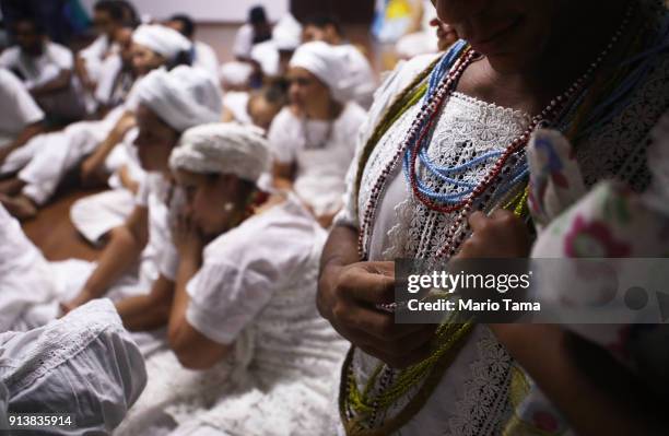 Worshippers gather before a Candomble ceremony honoring the goddess Oxum on February 2, 2018 in Sao Goncalo, Brazil. Candomble is an Afro-Brazilian...