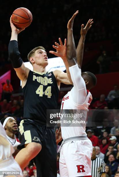 Isaac Haas of the Purdue Boilermakers attempts a shot as Mamadou Doucoure of the Rutgers Scarlet Knights defends during the first half of a game at...