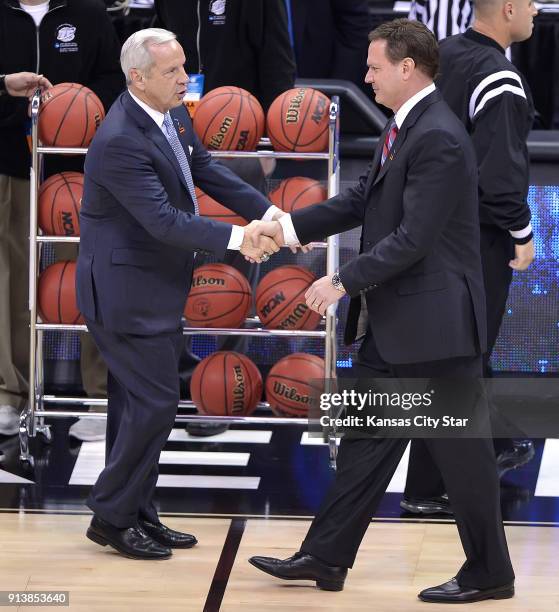 North Carolina head coach Roy Williams, left, greets Kansas head coach Bill Self prior to a third-round game in NCAA Tournament at the Sprint Center...
