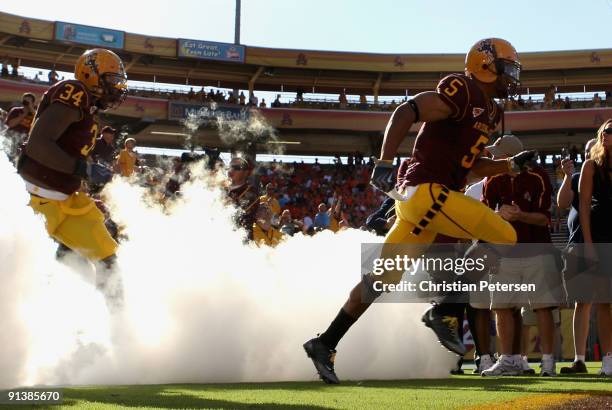 Kerry Taylor and James Brooks of the Arizona State Sun Devils runs out onto the field before the college football game against the Oregon State...