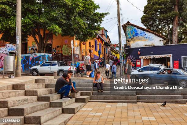 bogotá, colombia - local colombians and tourists in the historic la candelaria district of the andean capital city. background: calle del embudo. - embudo stock pictures, royalty-free photos & images