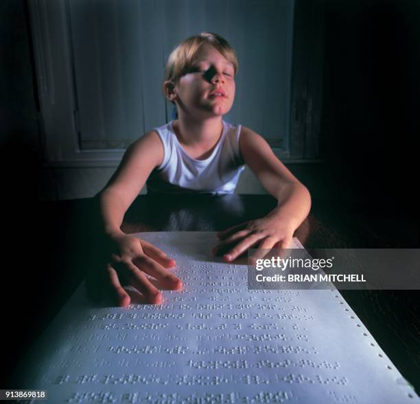 blind girl reading braille with her fingers - blind girl stock pictures, royalty-free photos & images