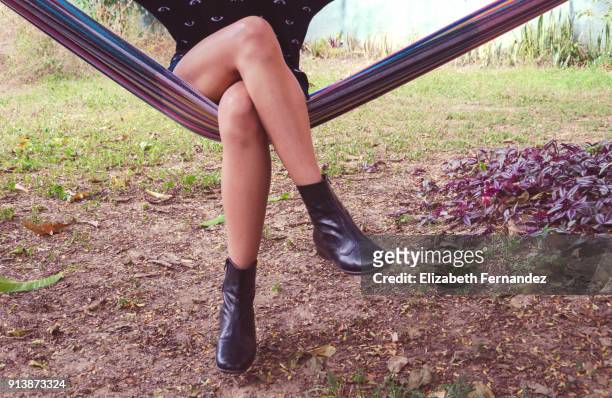 young woman sitting in hammock - legs crossed at knee stock pictures, royalty-free photos & images