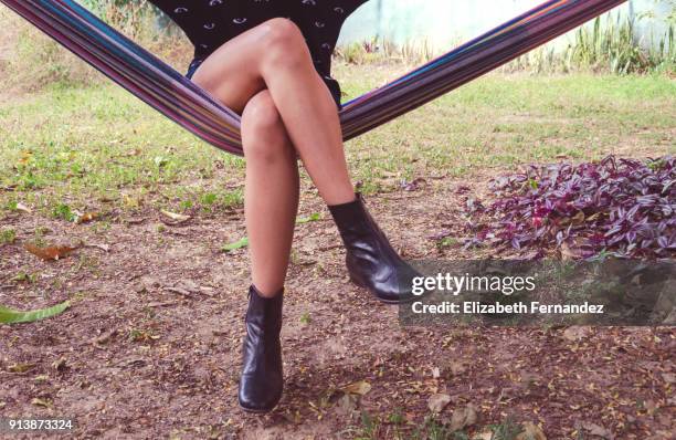 young woman sitting in hammock - korslagda ben bildbanksfoton och bilder