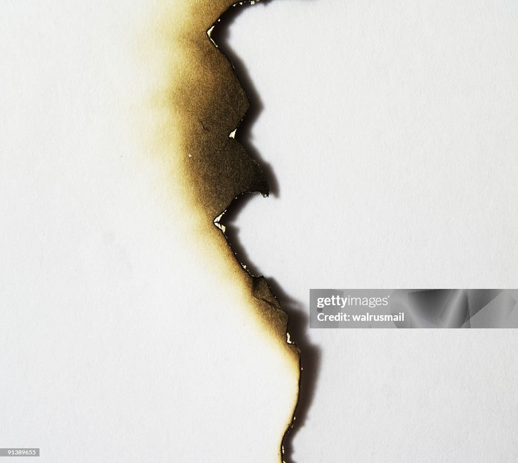 Uneven burned edge of a piece of paper
