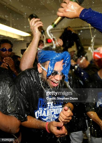 James Loney of the Los Angeles Dodgers is doused with champagne as they celebrate after the game with the Colorado Rockies on October 3, 2009 at...