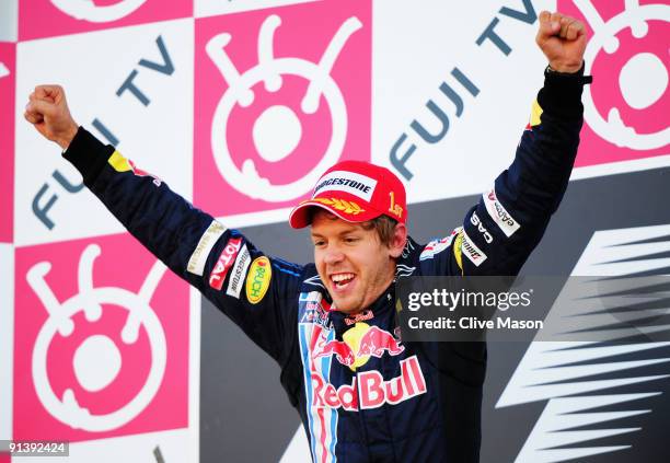 Race winner Sebastian Vettel of Germany and Red Bull Racing celebrates on the podium following the Japanese Formula One Grand Prix at Suzuka Circuit...